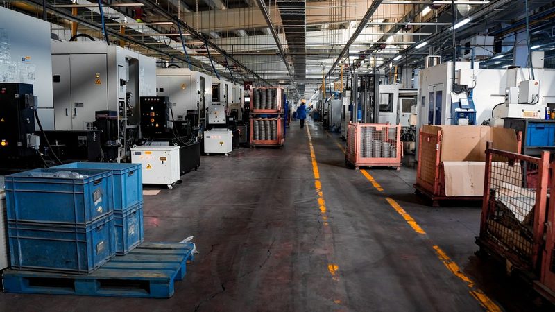 Industrial factory floor with machinery, crates and workstations