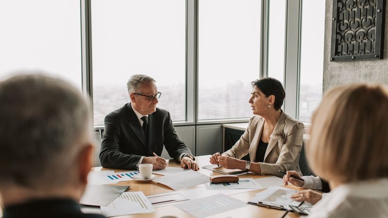 Business professionals in a strategy meeting around a conference table