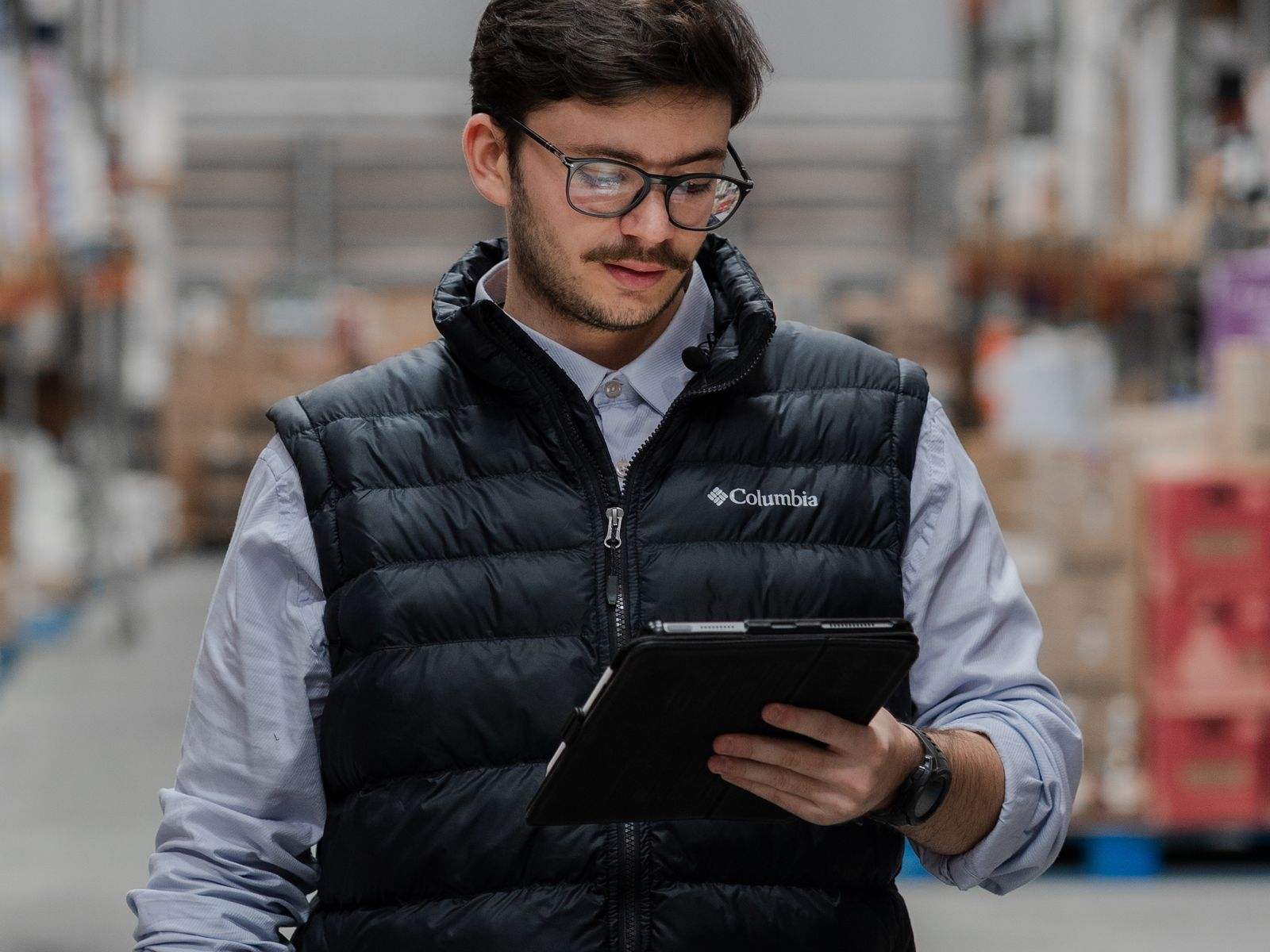 Warehouse worker ordering an approved part on a tablet