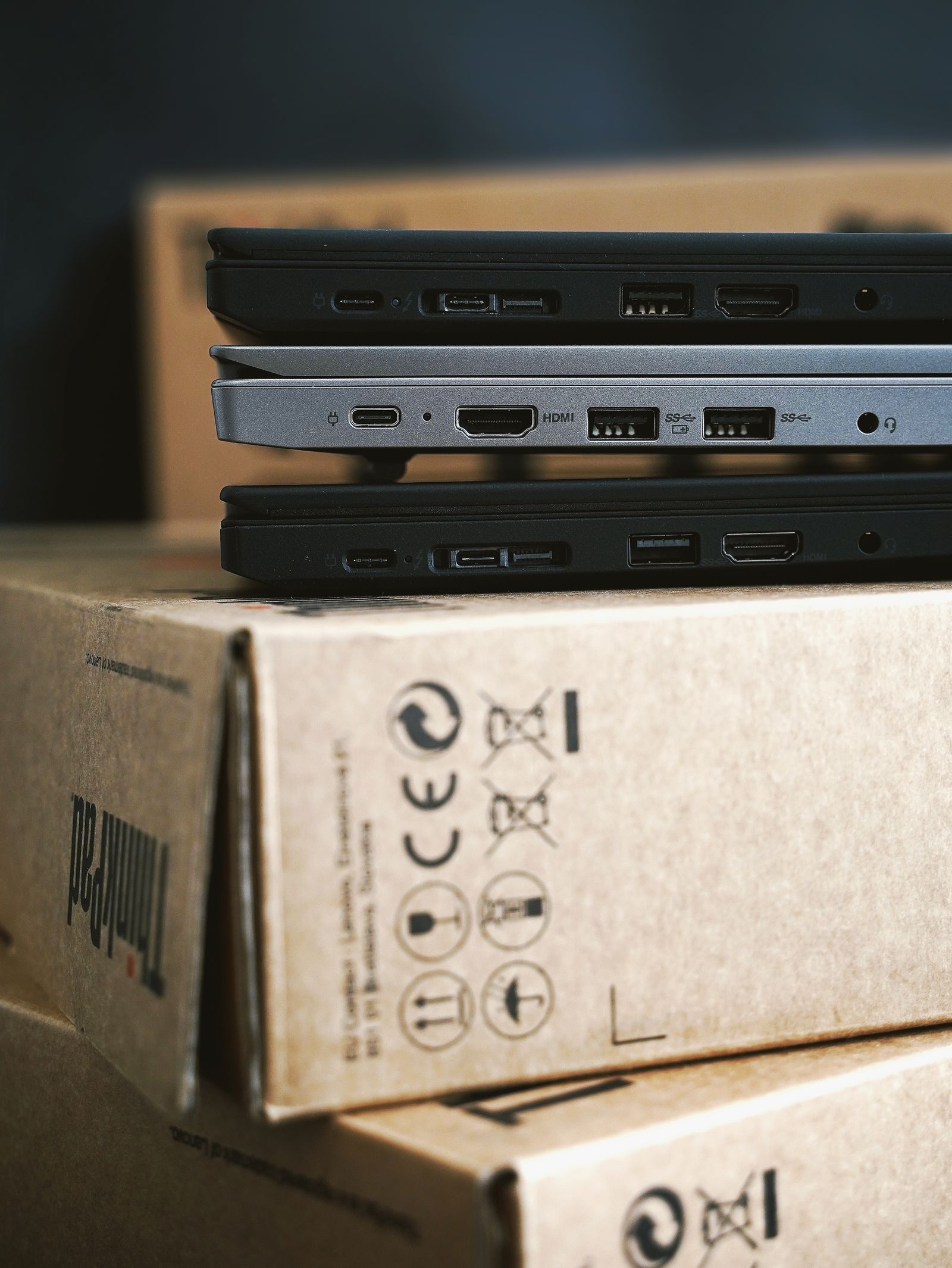 New laptops stacked on their delivery boxes ready for deployment