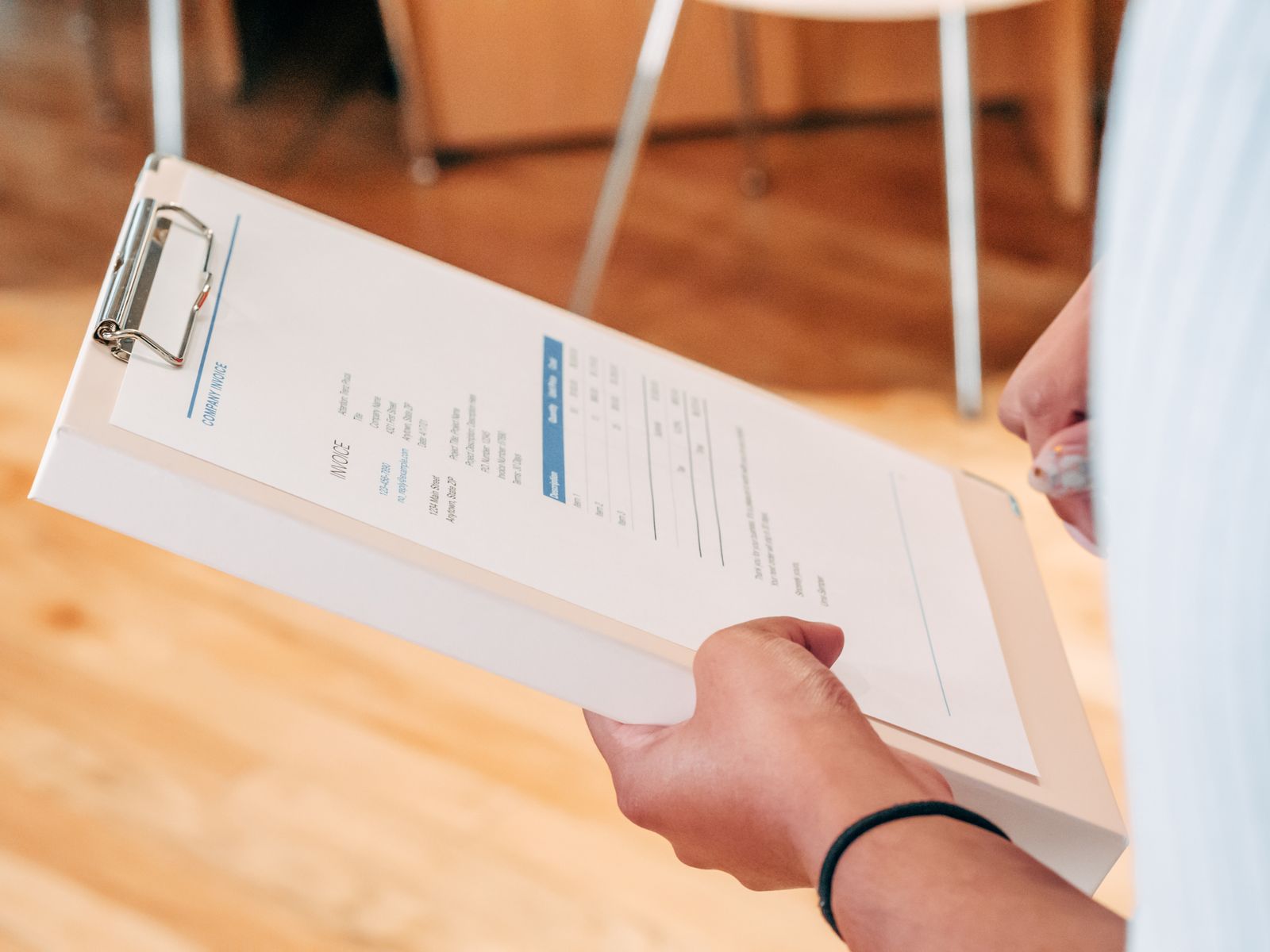 Purchase order documents being checked on a clipboard