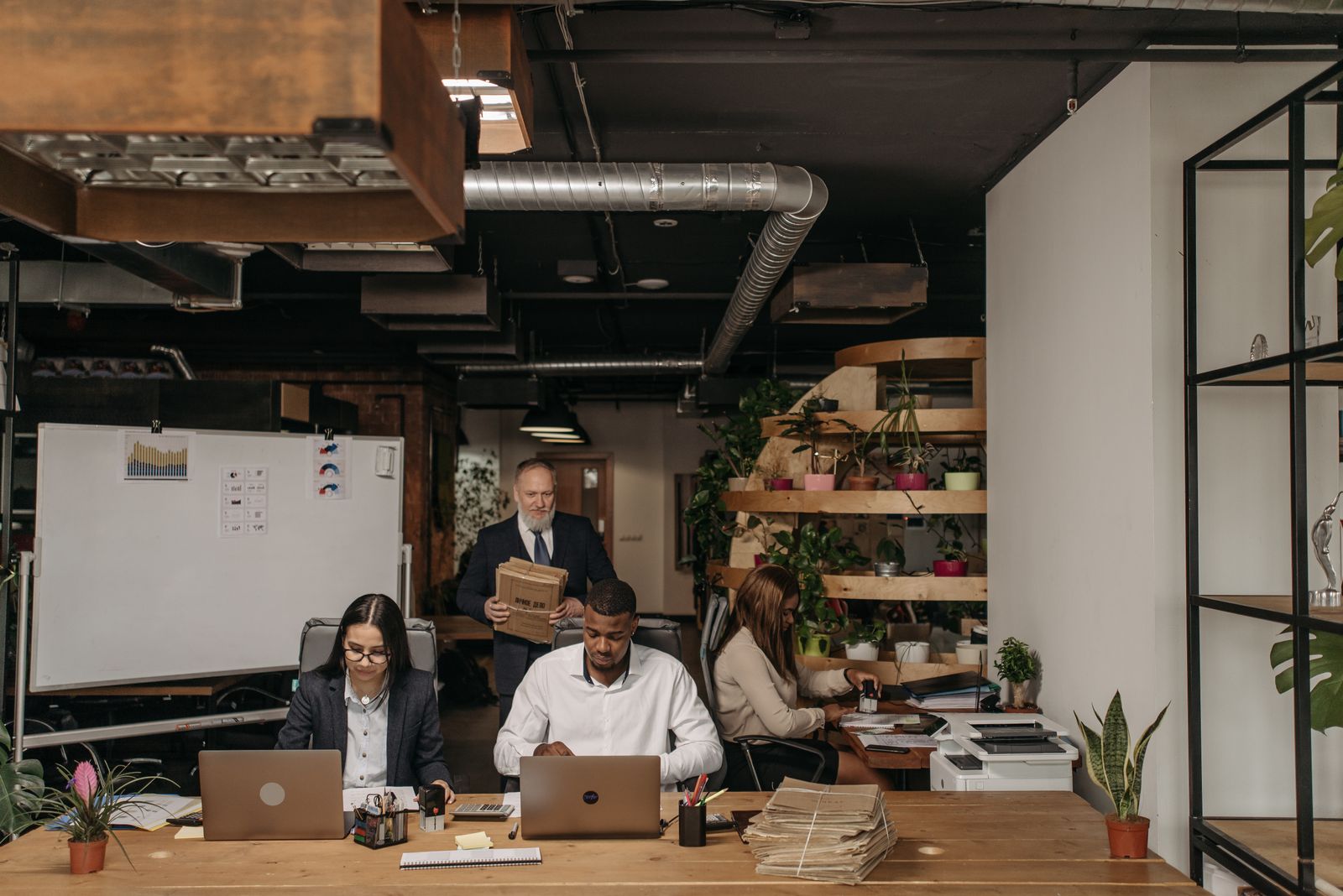 Procure-to-pay team working requisitions, orders and invoices at their desks