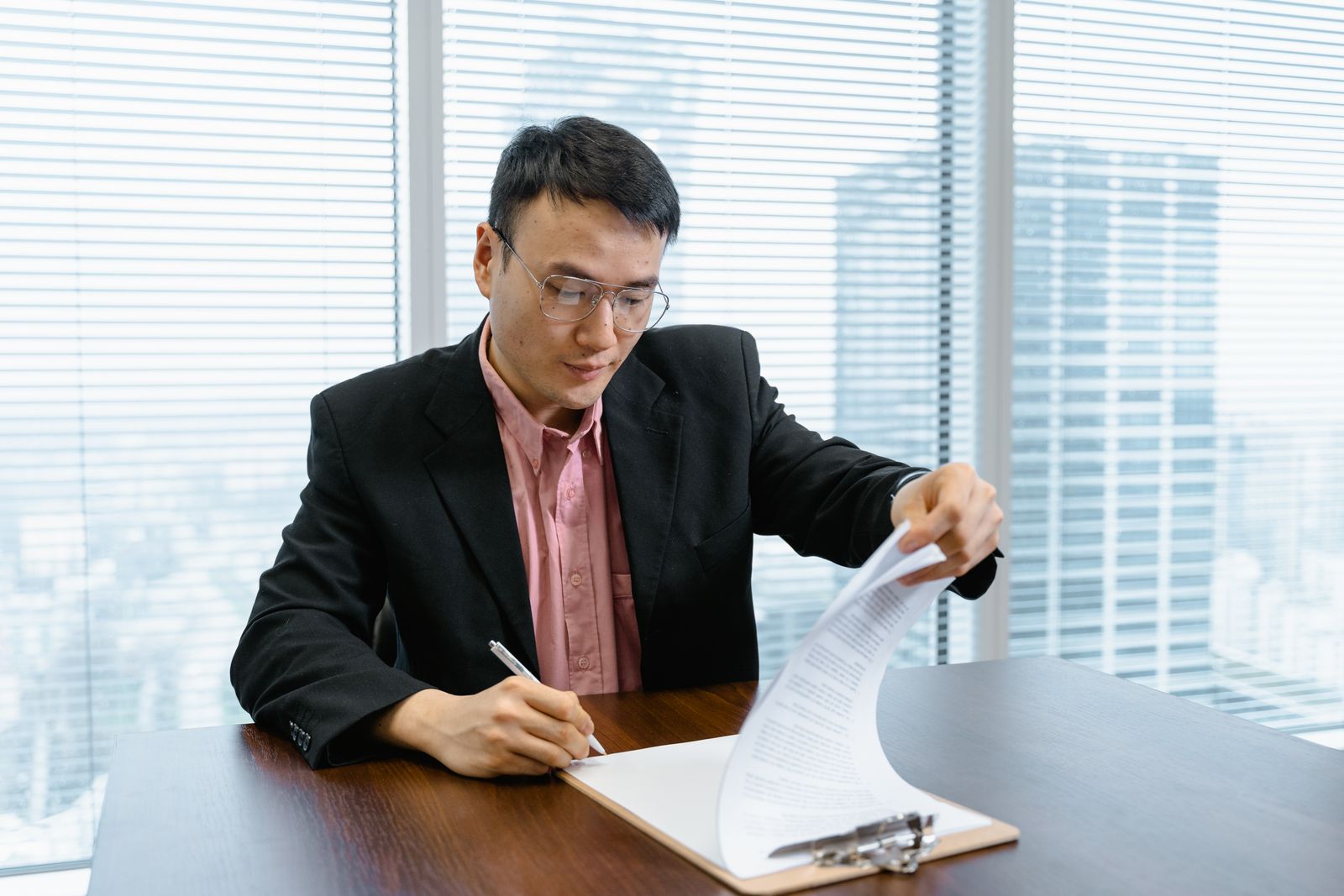 Approver signing off a purchase requisition at a desk