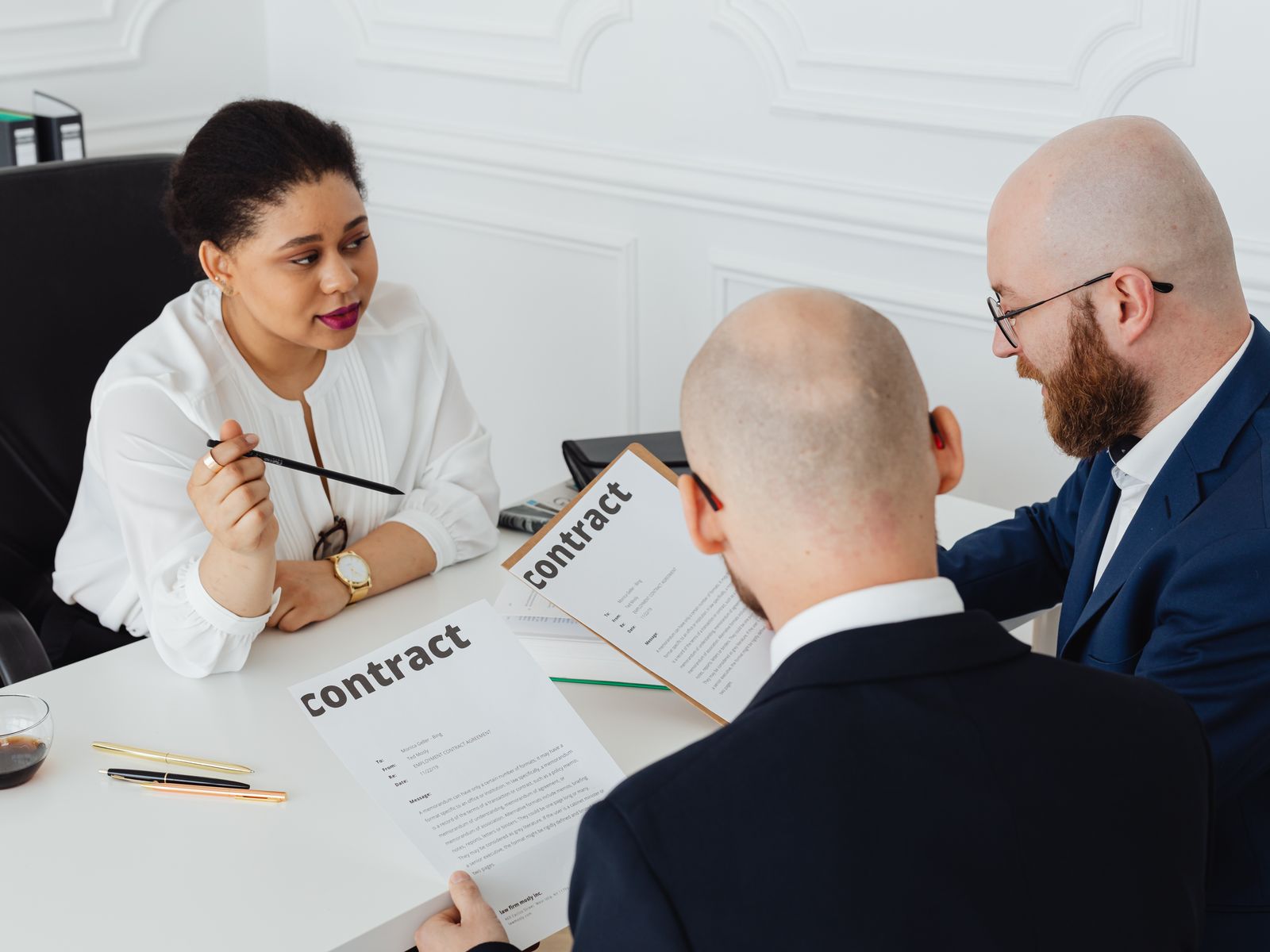 Team comparing supplier bids around a contract
